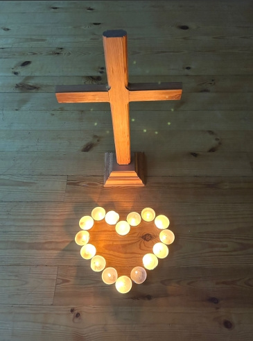 Kuvassa kynttilä ja risti